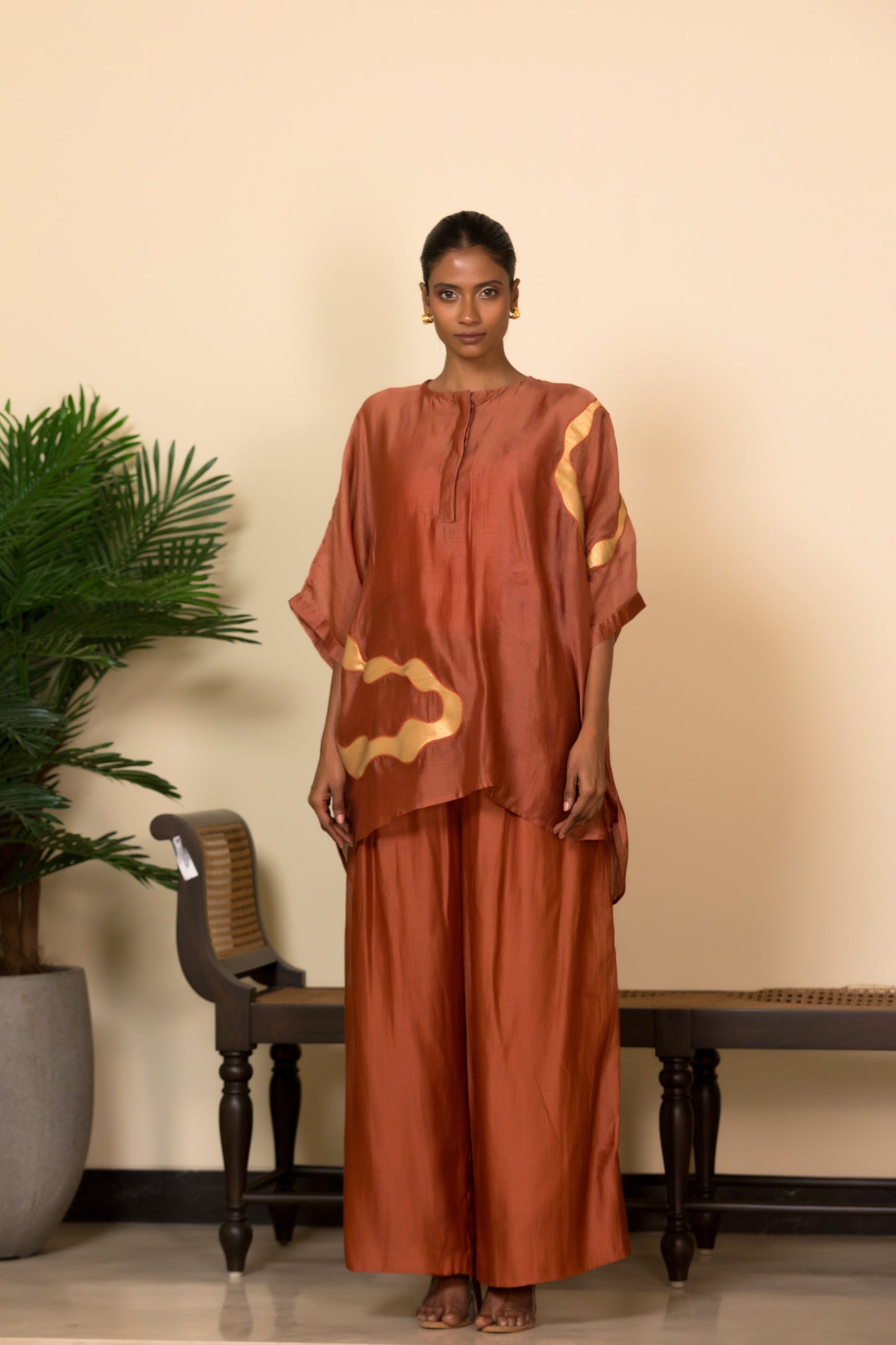 Rust Banarasi silk shirt with handcrafted asymmetrical patchwork for women, Indian luxury designer top styled with matching silk pants.