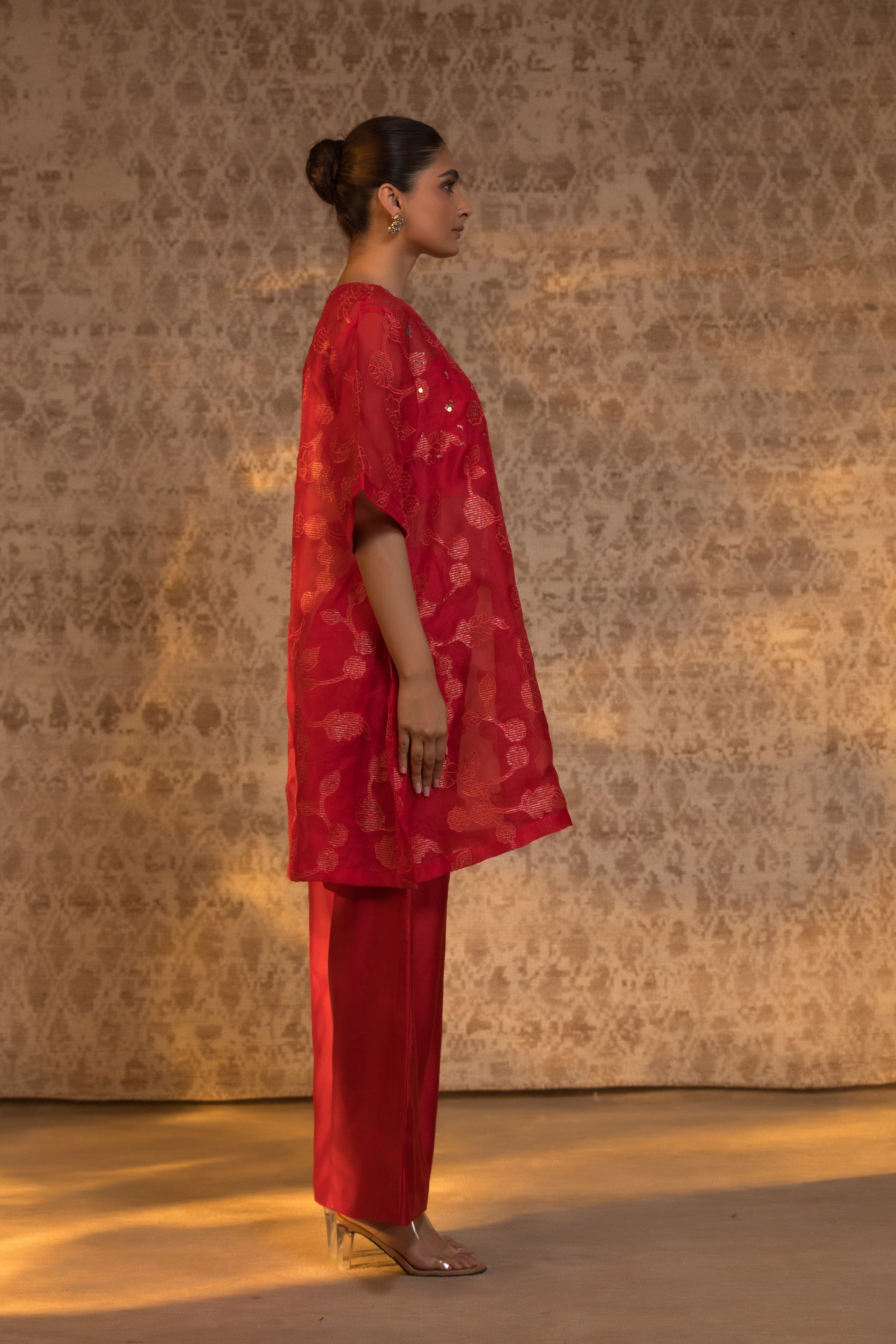 Profile view of a red organza silk kurta set with a luxurious finish