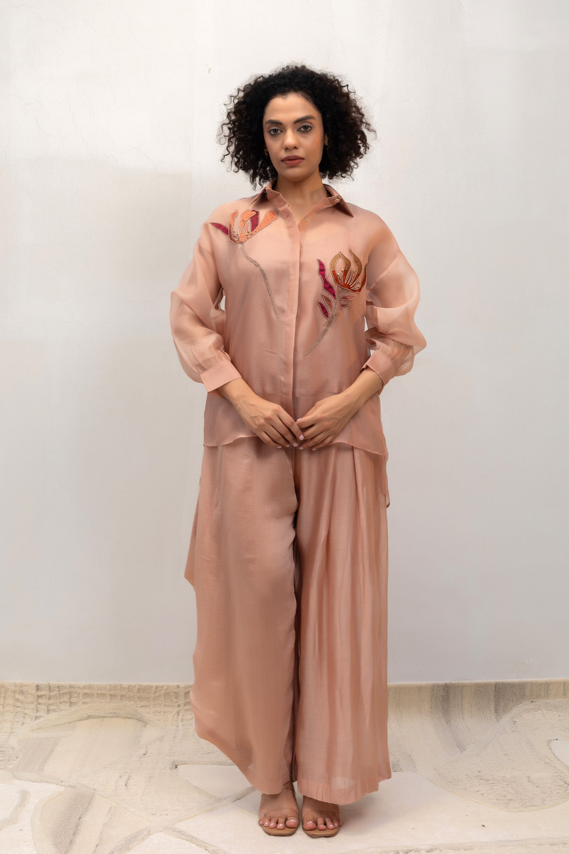 Model in a peach tissue-flower shirt and asymmetric cowl pant set — Eeda