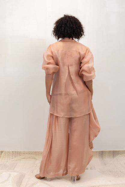 Model in a peach organza tissue-flower shirt styled with trousers — Eeda