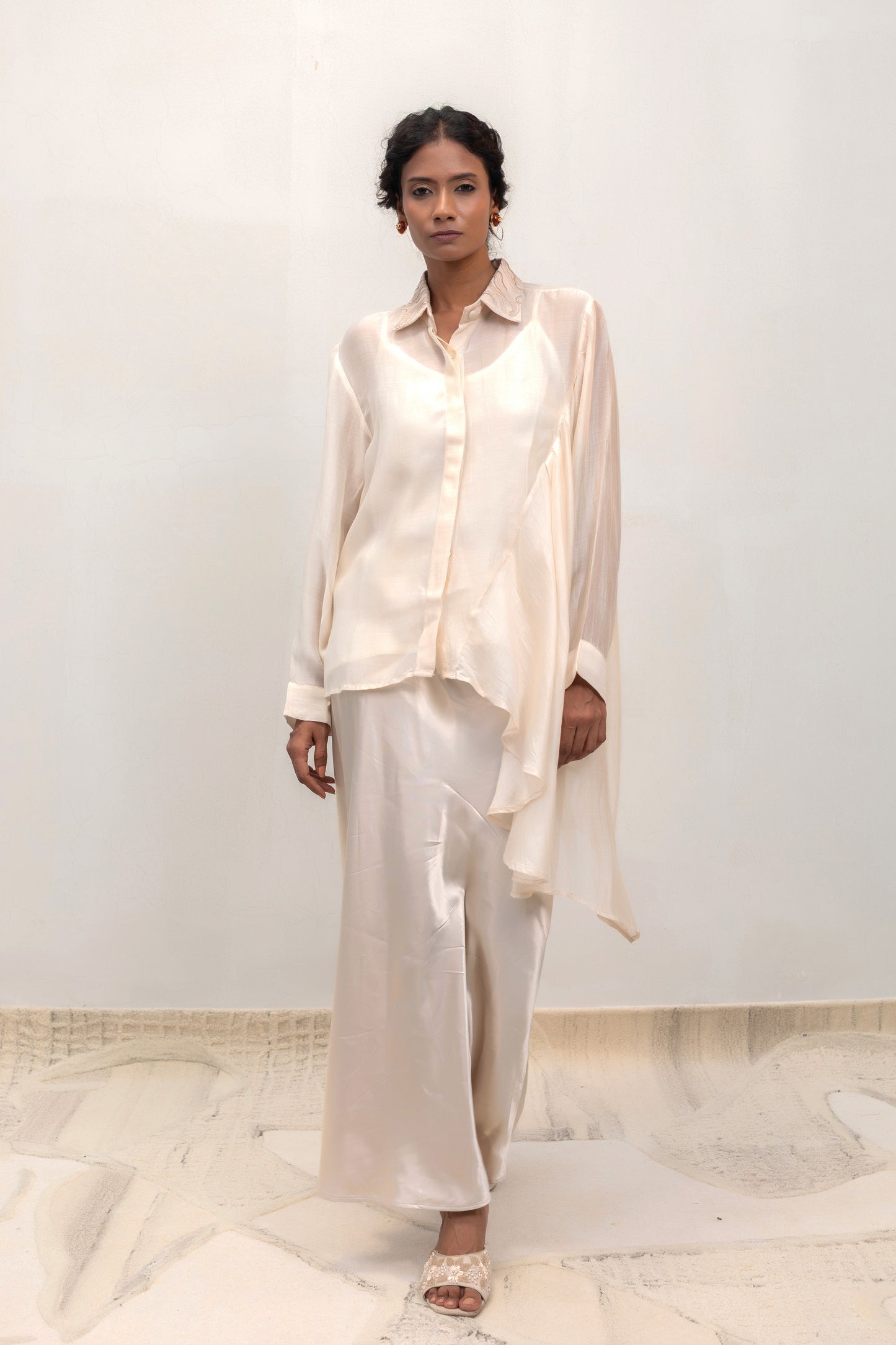 Ivory high-low shirt with an embellished collar, styled with trousers — Eeda