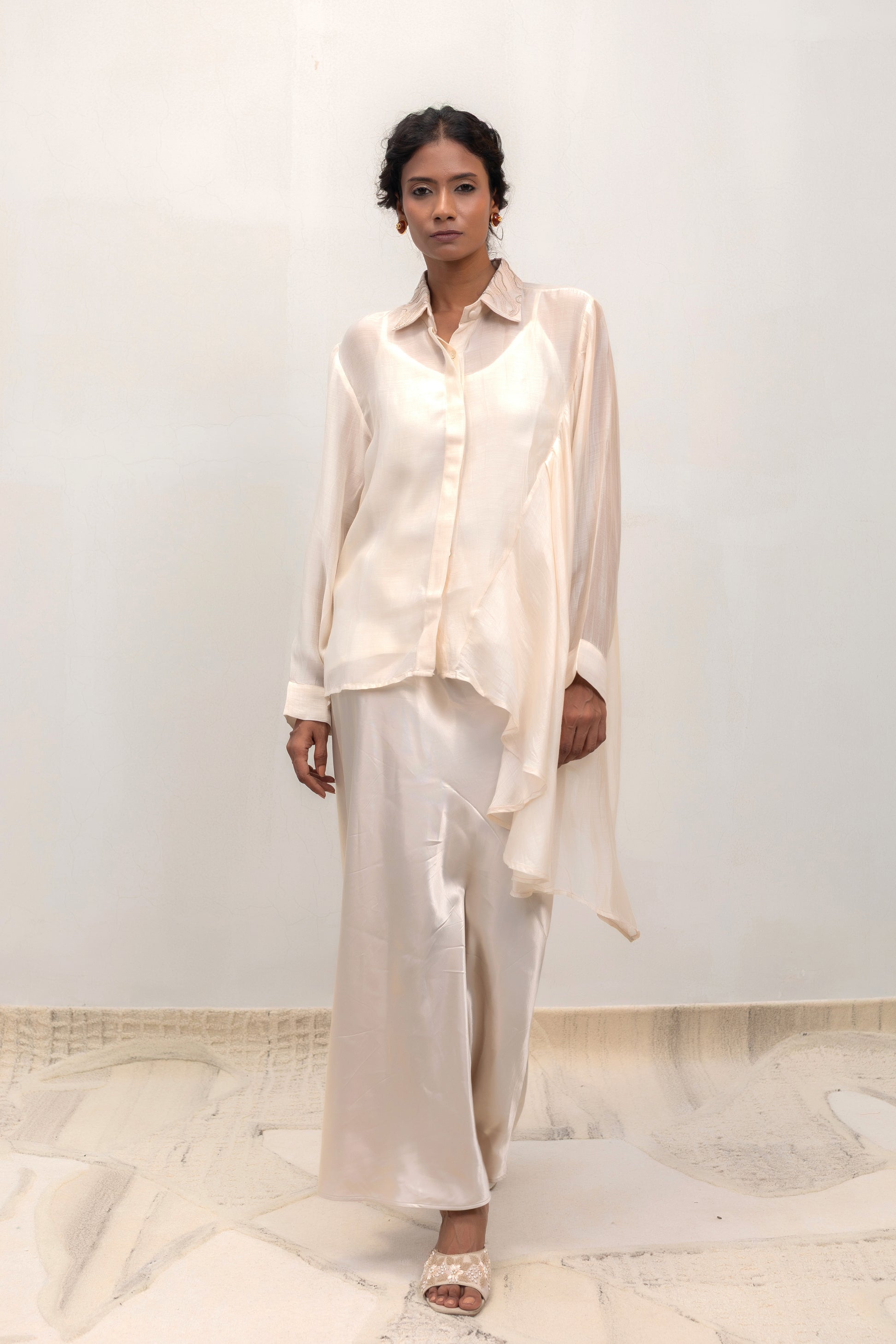 Ivory high-low shirt with an embellished collar, styled with trousers — Eeda