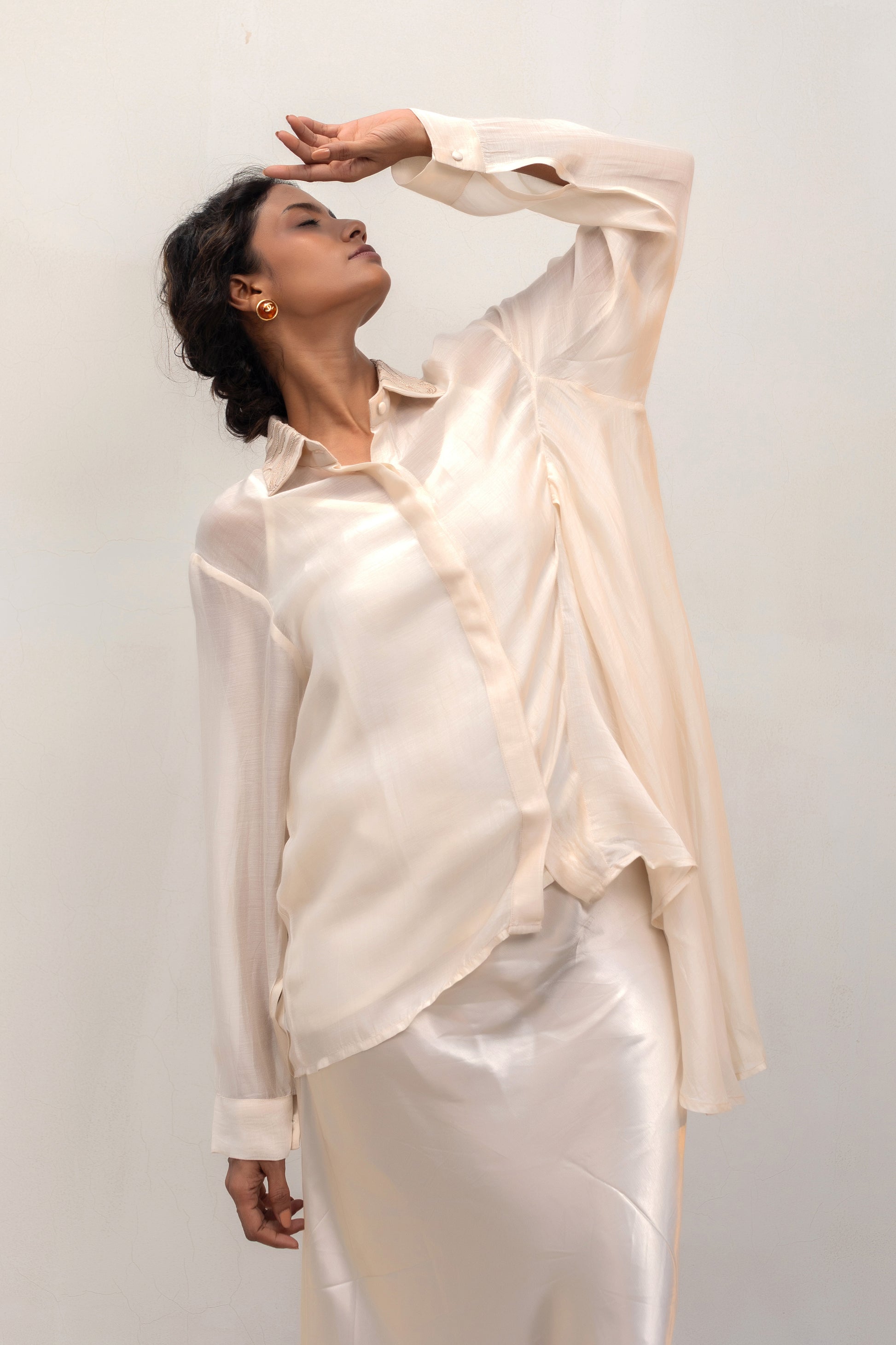 Contemporary offwhite party-wear shirt with embellished collar and relaxed fit — Eeda Spotlight