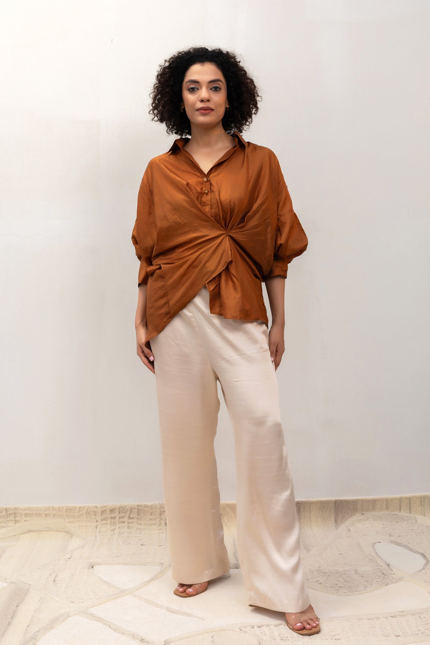 Camel draped Twist shirt styled with trousers — Eeda Spotlight