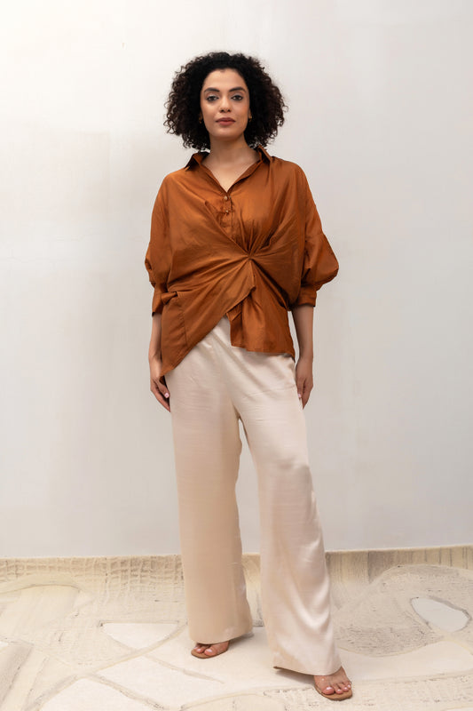 Camel draped Twist shirt styled with trousers — Eeda Spotlight