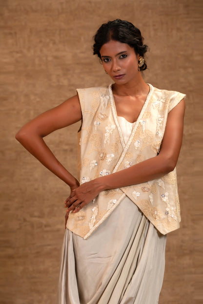 Model in an embellished ivory jacket with a pastel-green cowl draped skirt — Eeda Taral