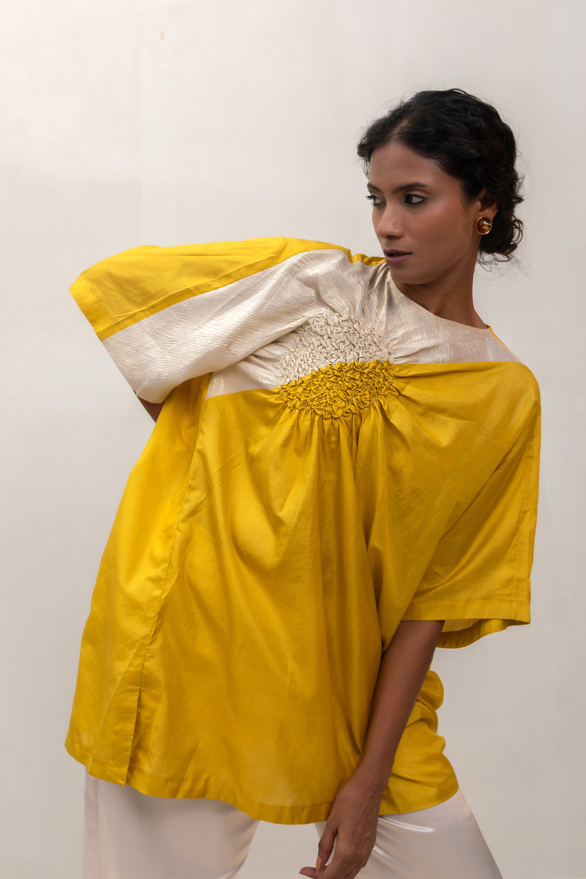 Model in a yellow Varq Cluster tunic styled with pants — Eeda