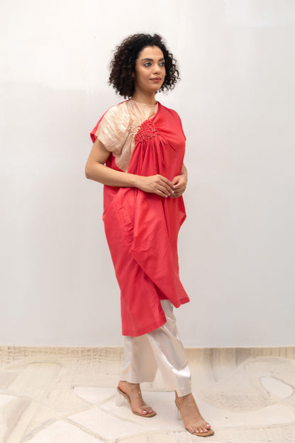 Model in a coral Varq Cluster tunic styled with pants — Eeda