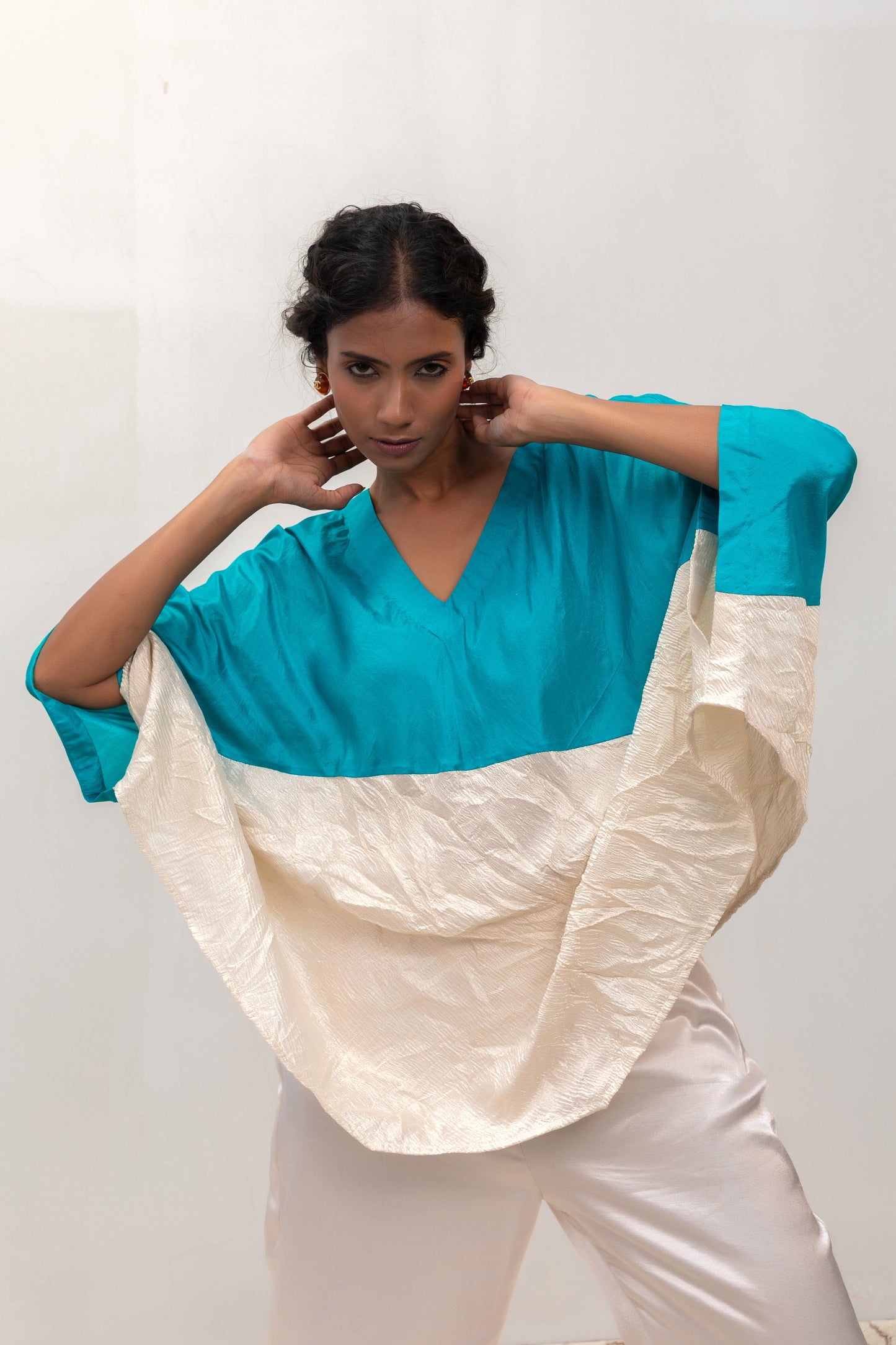 Model in a blue Varq Horizon Top styled with pants — Eeda