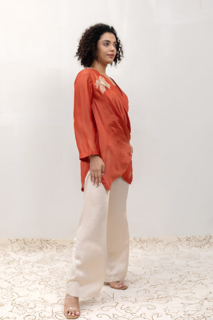 Model in a rust Varq Petals drape top styled with pants — Eeda