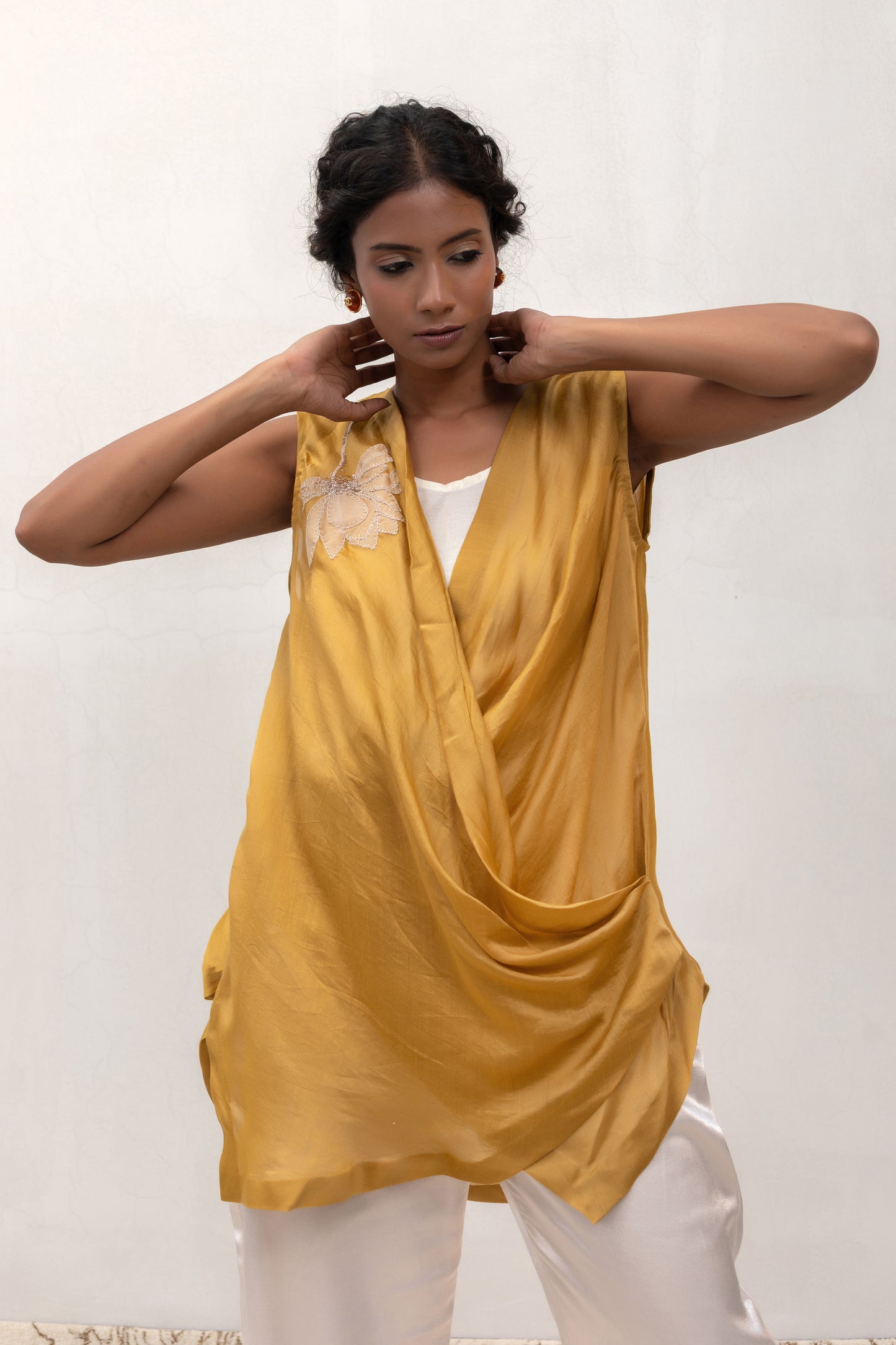 Model in a yellow Varq Petals drape top styled with pants — Eeda