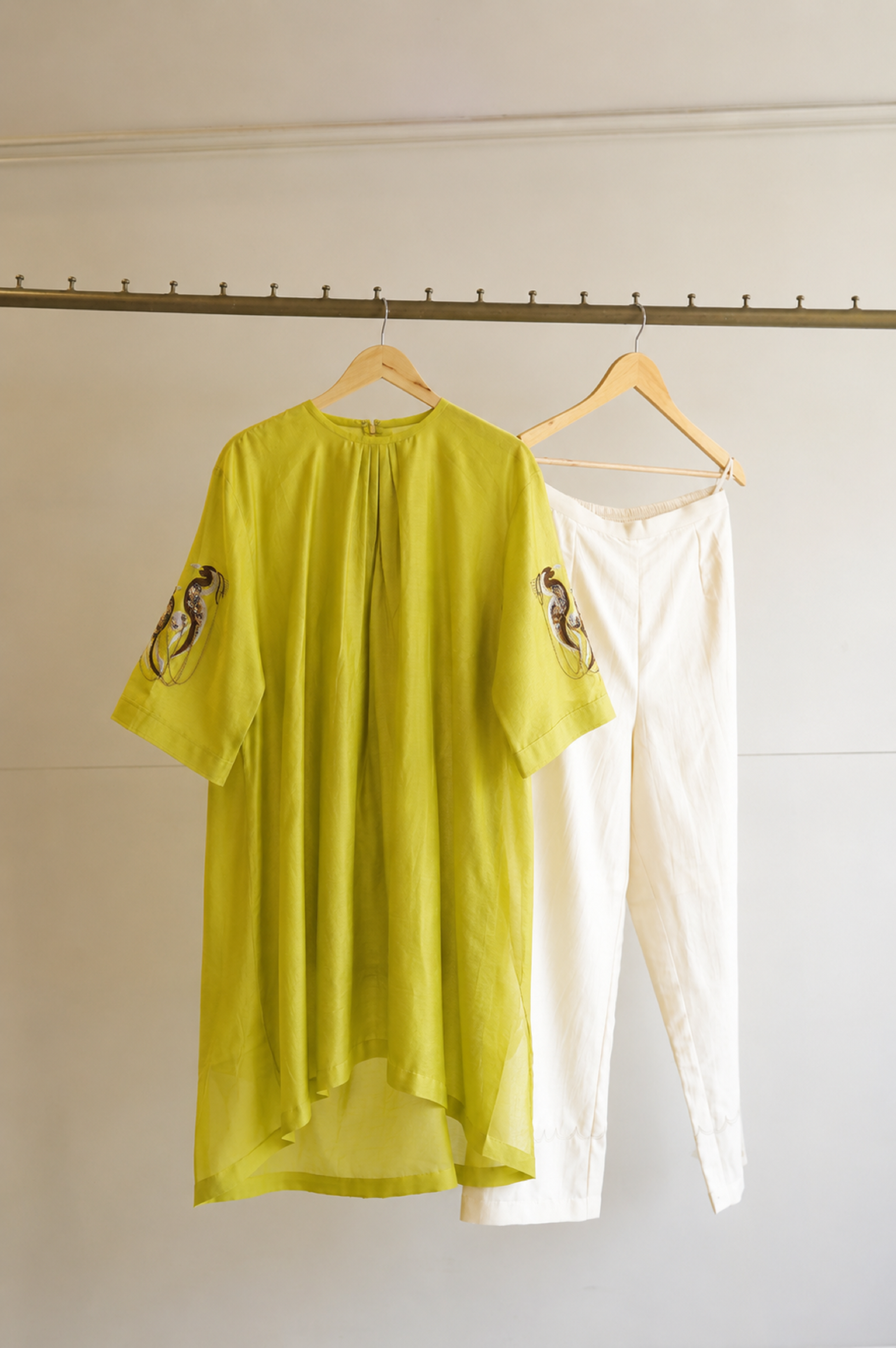 eeda Tinka — lime green chanderi gathered kurta with hand-embroidered sleeve and chain detail, paired with white straight trousers, handcrafted in Varanasi