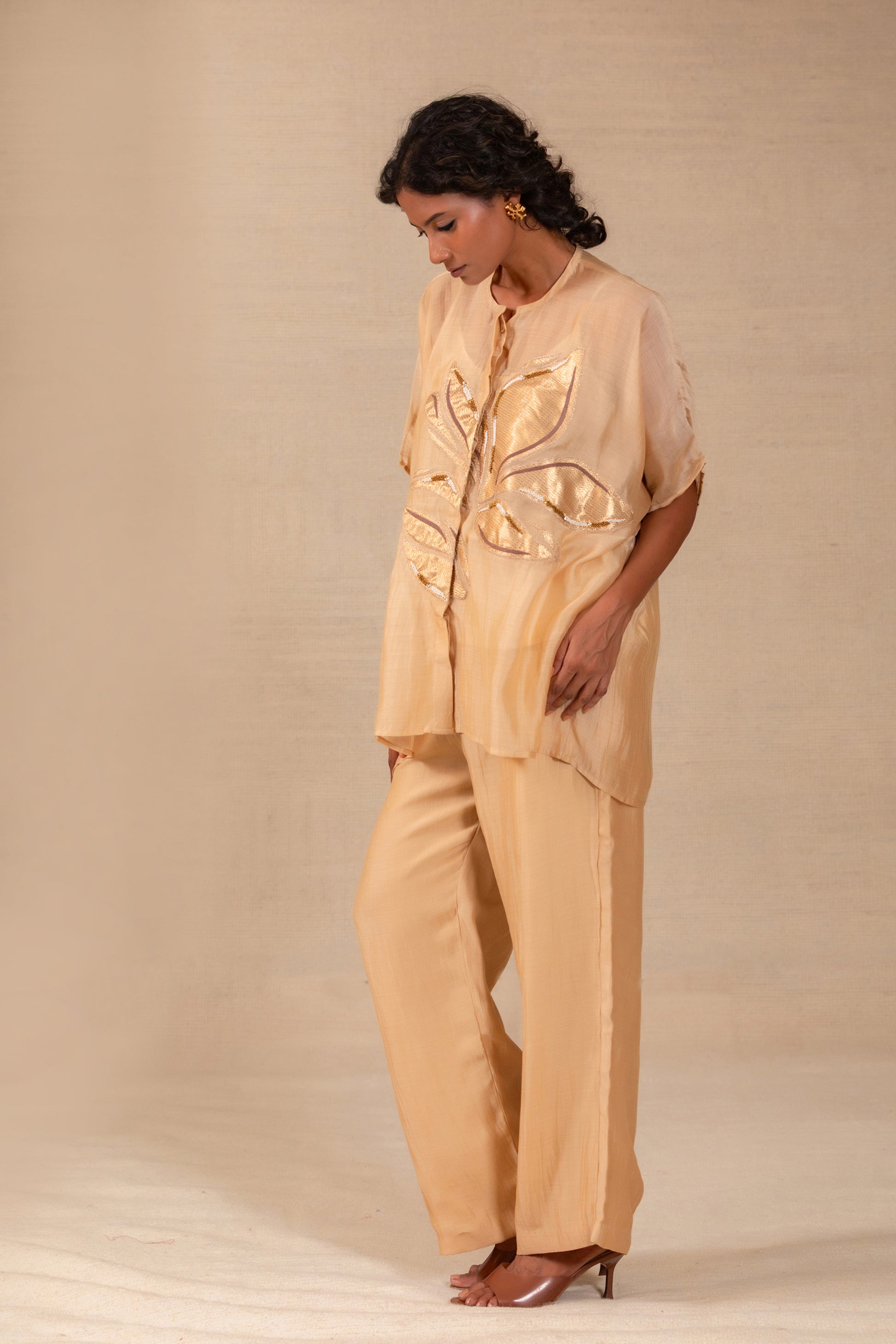 Model in a beige silk-Chanderi drop-shoulder co-ord set with gold leaf appliqué — Eeda Gulnaar