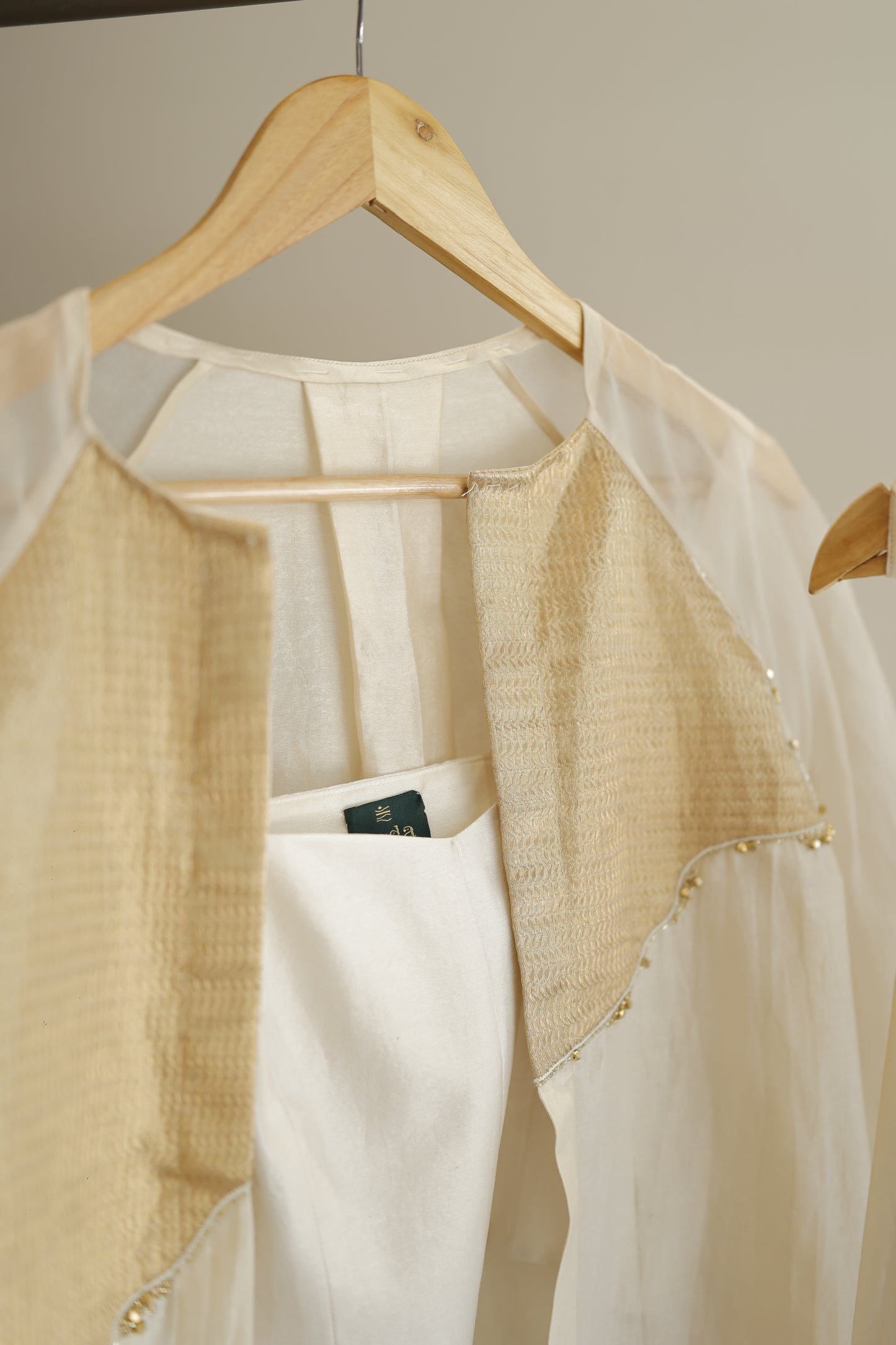 eeda ivory chanderi kurta set with gold silk tissue patchwork, side view showing relaxed silhouette and gathered cuff detail