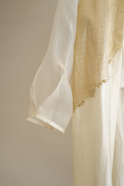 eeda ivory chanderi kurta set close-up showing hand-finished gold tissue patchwork edging and bishop sleeve