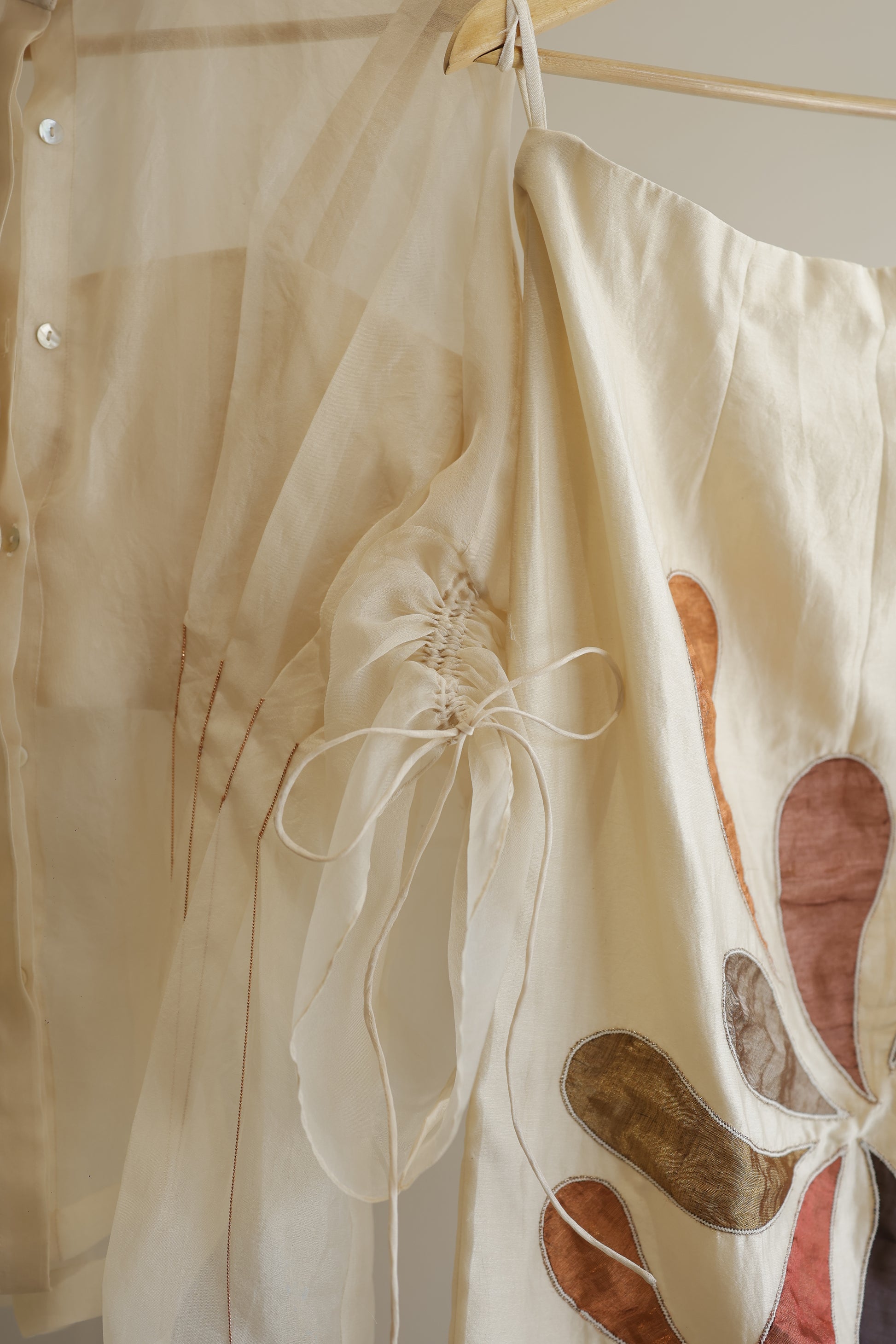 eeda ivory silk organza pleated shirt, side view showing pleat detail and relaxed silhouette