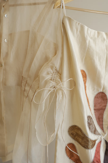 eeda ivory silk organza pleated shirt, side view showing pleat detail and relaxed silhouette