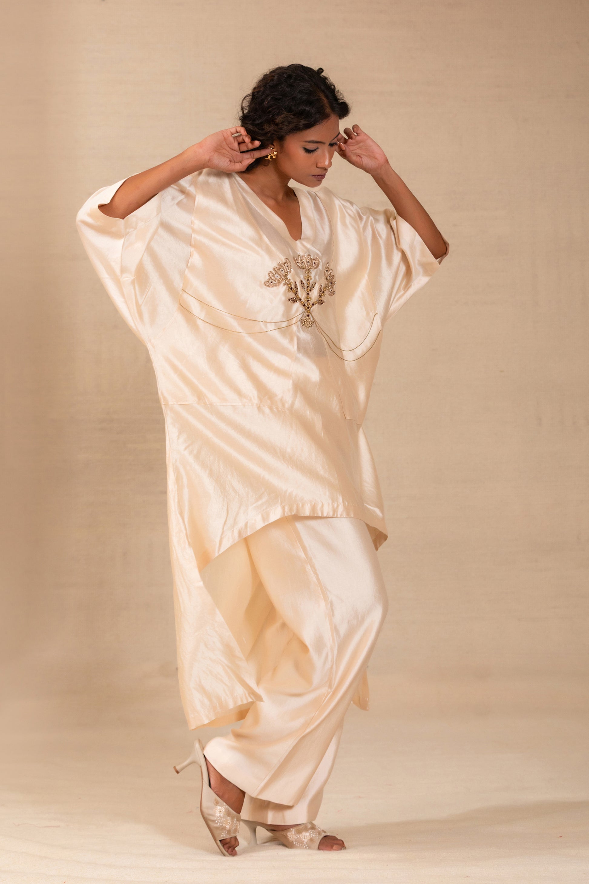Model in an ivory kaftan-style silk kurta set with folk motif and silk pants — Eeda Silsila