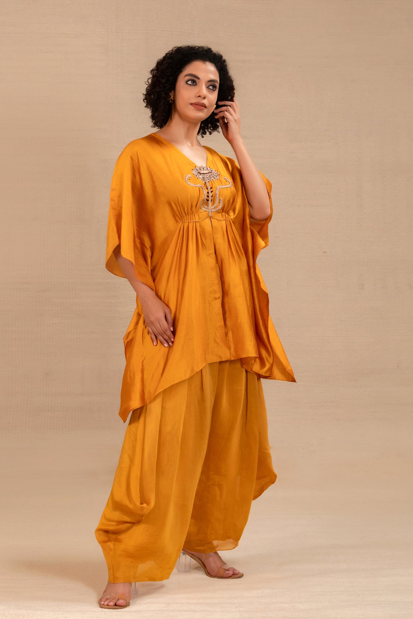 Model in a marigold cowl kaftan set with draped silk pants — Eeda Silsila