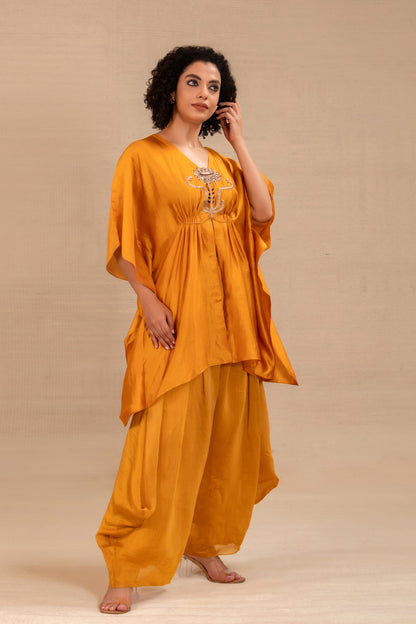 Model in a marigold cowl kaftan set with draped silk pants — Eeda Silsila
