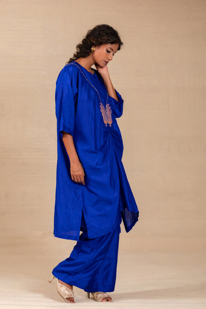 Model in an electric blue silk kurta set with paisley motifs and wide silk pants — Eeda Silsila