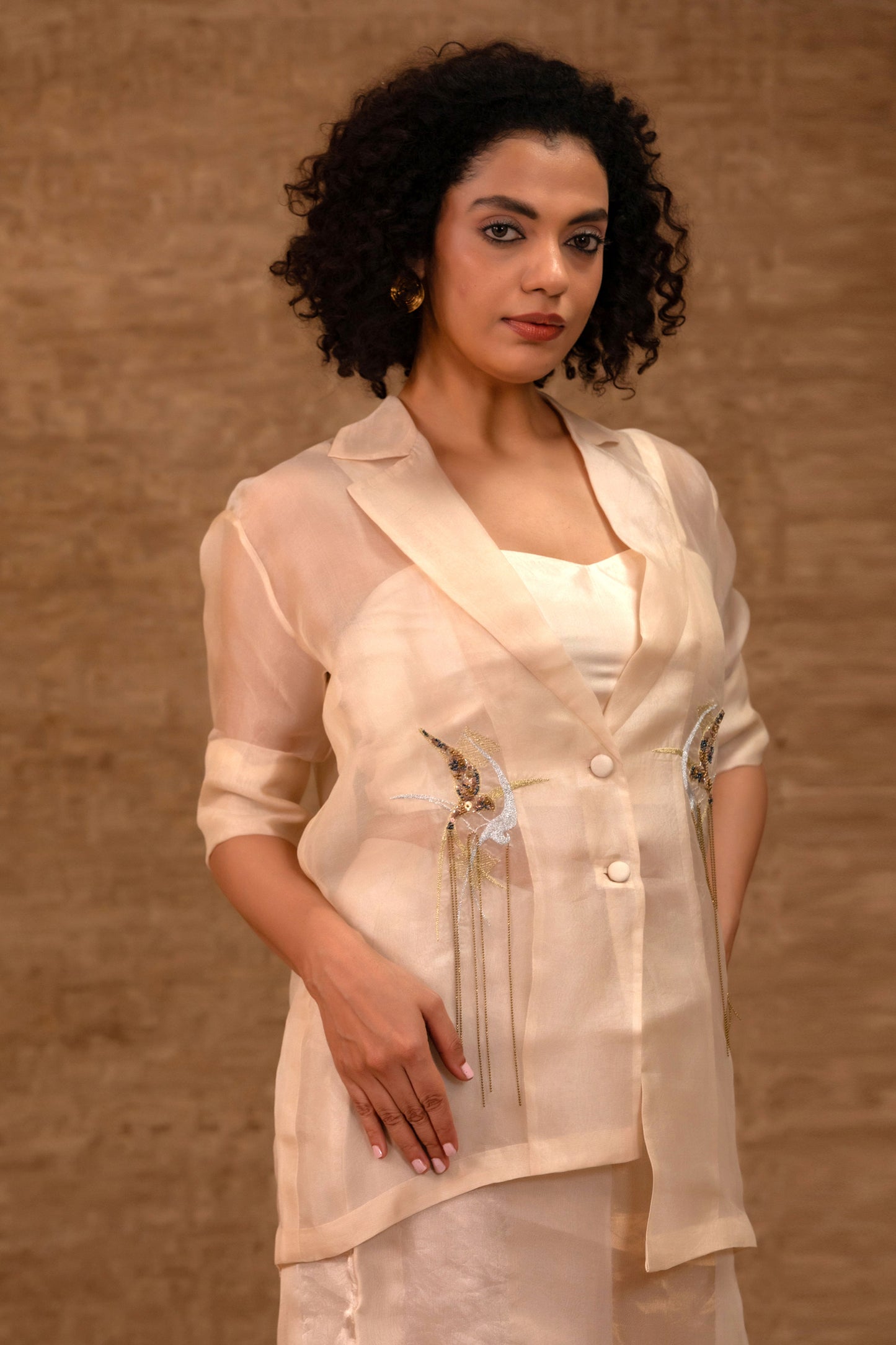 Model in an ivory organza embroidered jacket set with a tissue skirt — Eeda Tinka